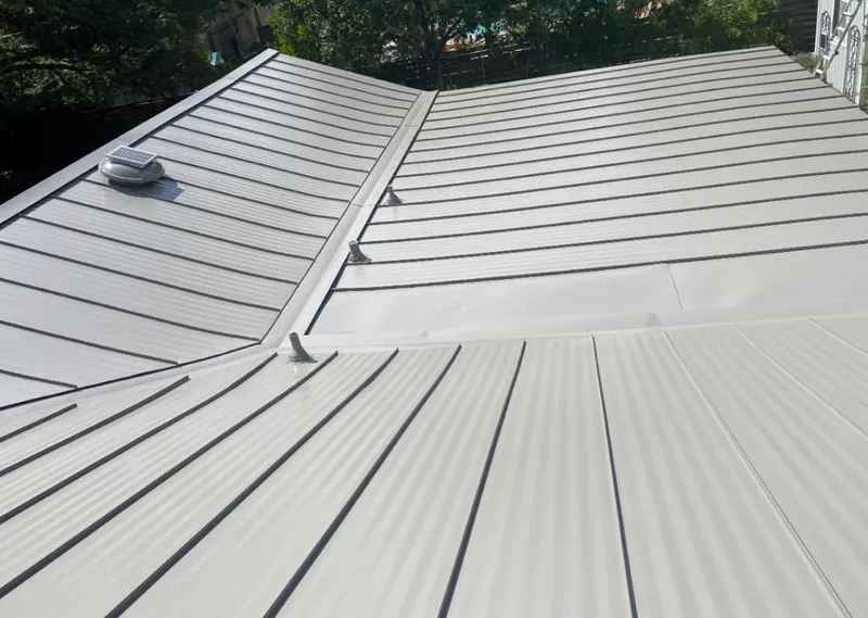 Solar attic fan installed on a metal roof for Roof Ventilation in Troutdale